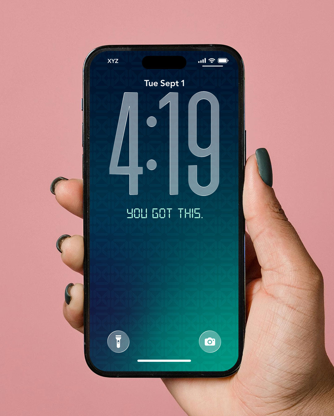 A hand with dark green nail polish holds a black smartphone showing a digital lock screen wallpaper with a blue-to-teal gradient and the text 'YOU GOT THIS.' against a solid pink background.