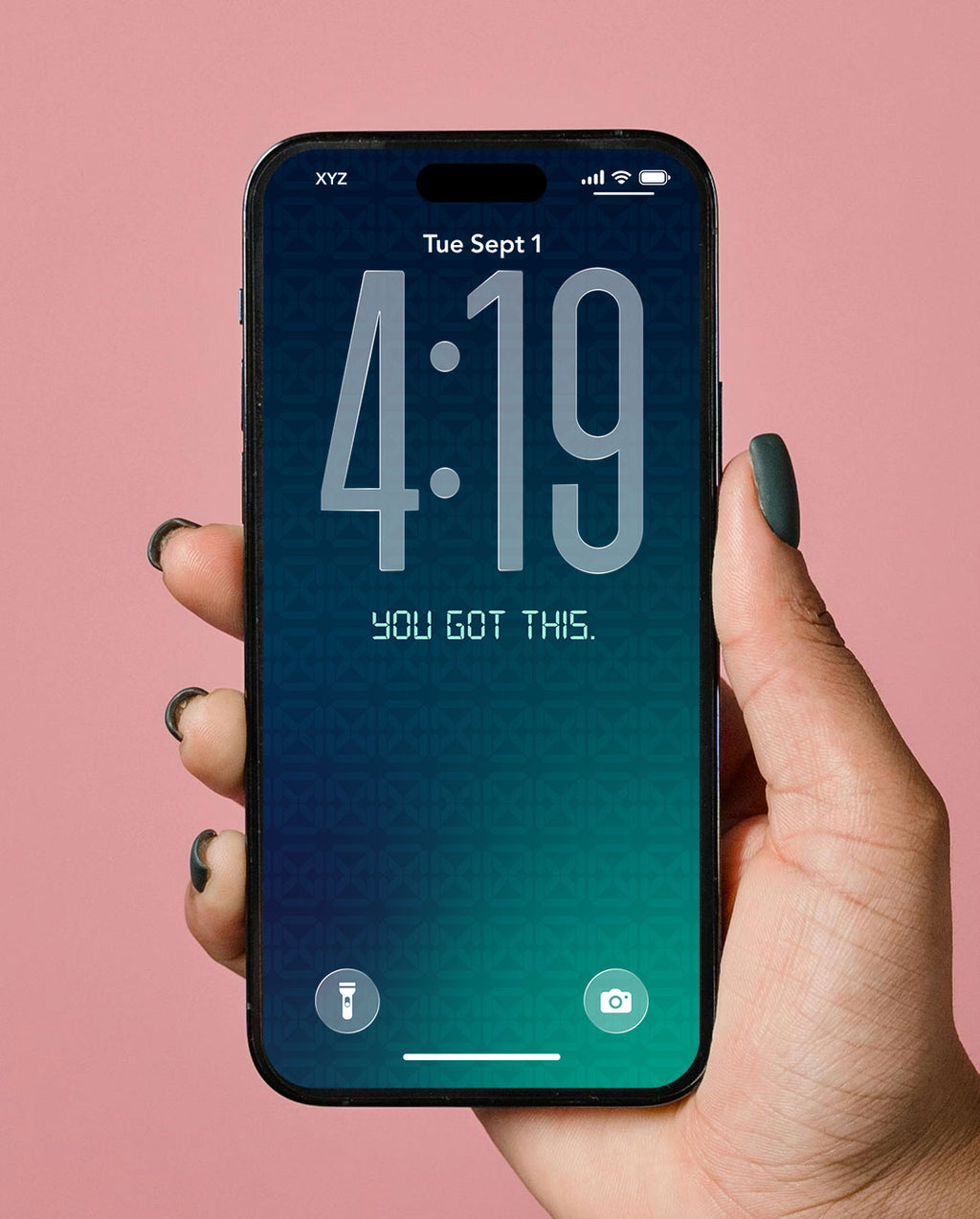A hand with dark green nail polish holds a black smartphone showing a digital lock screen wallpaper with a blue-to-teal gradient and the text 'YOU GOT THIS.' against a solid pink background.